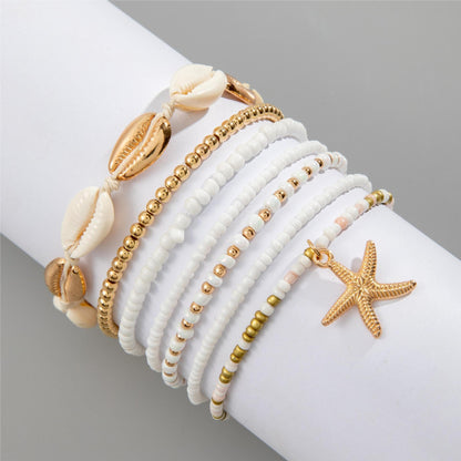 Strand Armband für Damen: 7-in-1 Style Schmuck mit Seesternen und Muscheln